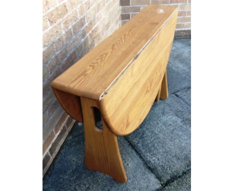 AN ERCOL LIGHT ELM DROP LEAF DINING TABLE  the oval top 107cm deep, 122cm wide (22cm with both leaves down)