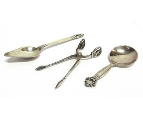 A GEORG JENSEN BLOSSOM PATTERN TONGS  1944-55 mark; a Georg Jensen Acorn pattern grapefruit spoon, post 1945 marks; and an Ac