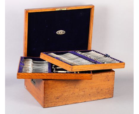 AN EDWARD VI OAK CANTEEN OF SILVER PLATED CUTLERY by Joseph Rodgers &amp; Sons of Sheffield having three lift out trays and c