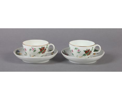 A PAIR OF RUSSIAN PORCELAIN CUPS AND SAUCERS each polychrome decorated with flowers and leafage, the interlaced handles mould