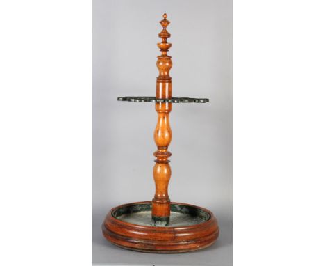 A 19TH CENTURY COUNTRY HOUSE FRUITWOOD AND CAST IRON UMBRELLA/STICK STAND, the turned post with urn finial set with green pai