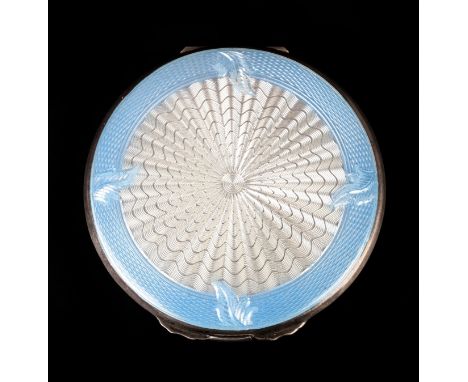 A SILVER AND ENAMEL POWDER COMPACT by Joseph Gloster Ltd c.1947, the pale blue and translucent guilloche front with engine tu
