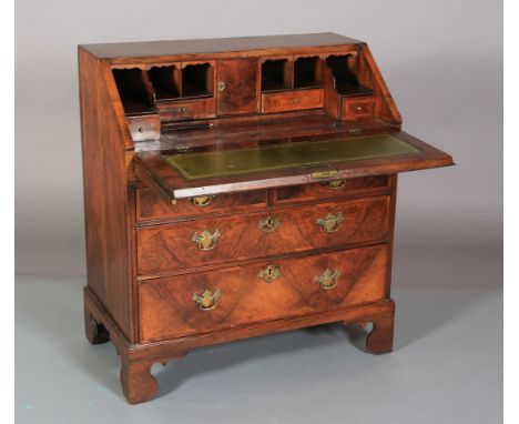 AN EARLY 18TH CENTURY FIGURED WALNUT CROSSBANDED AND BANDED BUREAU having a drop front, the interior fitted with small drawer