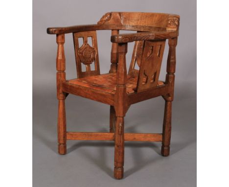 A THOMPSON OF KILBURN 'MOUSEMAN' ENGLISH OAK MONK'S CHAIR the top rail terminating with a face mask to either end, above a pi