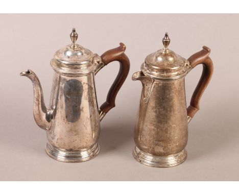 A PAIR OF GEORGE VI SILVER CAFE AU LAIT POTS, of 18th century design, having stained wood handles, domed covers with urn fini