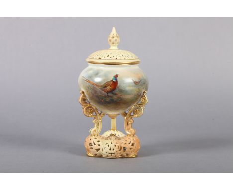 A ROYAL WORCESTER POT POURRI VASE AND COVER painted by Jas Stinton with cock and hen pheasant in undergrowth, the blush ivory