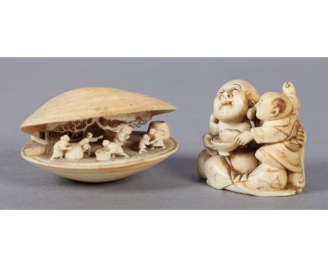 A LATE 19TH CENTURY JAPANESE NETSUKE of buddha and a young child, unsigned, 4cm high, together with a netsuke carved as a cla