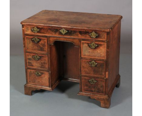 AN 18TH CENTURY WALNUT CROSSBANDED KNEEHOLE DESK, the top quarter veneered and inlaid with herringbone banding, re-entrant co