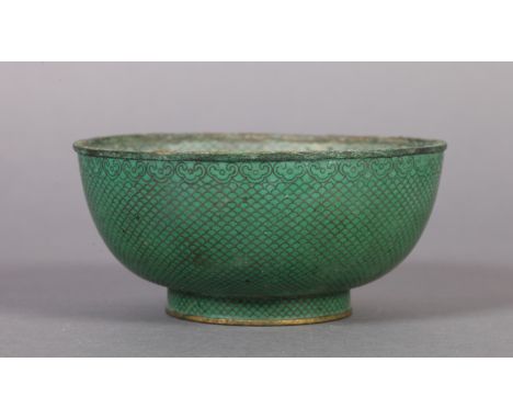 A CHINESE GREEN CLOISONNE ENAMEL CIRCULAR FOOTED BOWL, the exterior with graduated scaling beneath a scroll border, the inter