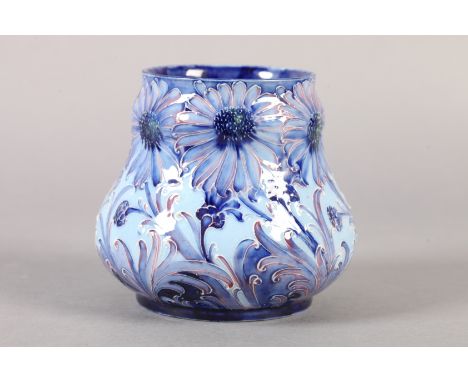 A WILLIAM MOORCROFT HESPERIAN DAISY design vase c.1902, tubelined and painted in shades of blue on a pale blue ground highlig