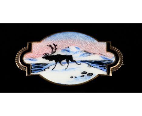 A NORWEGIAN SILVER GILT ENAMEL BROOCH BY NORNE, the polychrome guilloche scene of a European moose silhouette against an Arct