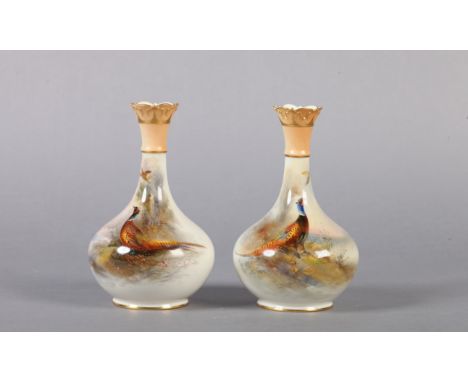 A PAIR OF ROYAL WORCESTER VASES painted by Jas Stinton with cock pheasants in a landscape, the bottle shaped body with narrow