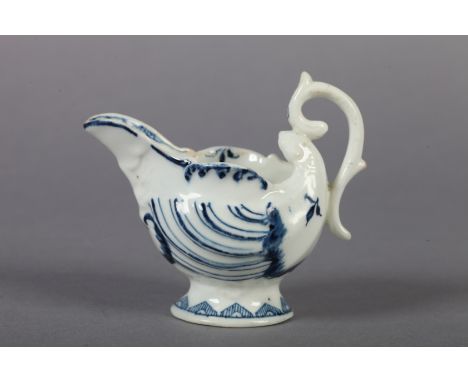 A DERBY BLUE AND WHITE PORCELAIN BUTTER BOAT c.1760 of moulded nautilus shape, the spout with entwined dolphins and trident, 