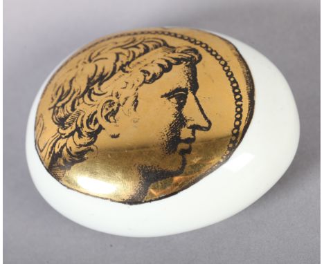 PIERO FORNASETTI (1913-1988) ITALY c.1950 an oval pebble-form paperweight printed in gilt and black with a Roman portrait in 