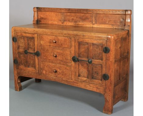 A THOMPSON OF KILBURN 'MOUSEMAN' ENGLISH OAK AND BURR OAK SIDEBOARD, c.1928/1930, adzed, having a raised back with half penny