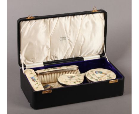 A GEORGE V FIVE PIECE SILVER GILT AND ENAMEL DRESSING TABLE SET each piece enamelled in green, blue, red and gilt with a Japa