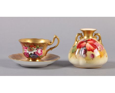 A ROYAL WORCESTER GILDED CABINET CUP AND SAUCER, the cup painted by E Barker with flowers against a mottled ground, the sauce