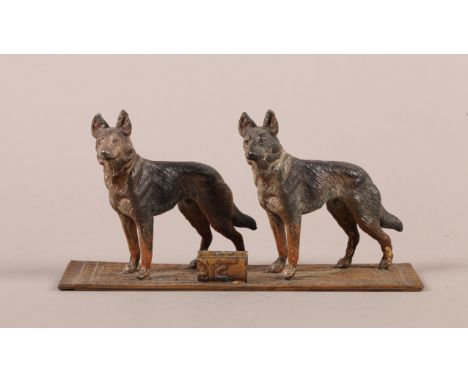 A COLD PAINTED GROUP OF ALSATIANS on an Eastern carpet, mounted with a small card holder, 15.5cm long 