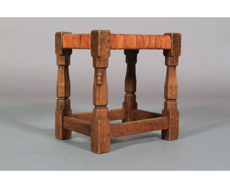 A THOMPSON OF KILBURN 'MOUSEMAN' ENGLISH OAK STOOL with woven leather seat, on octagonal turned and square framing, carved in