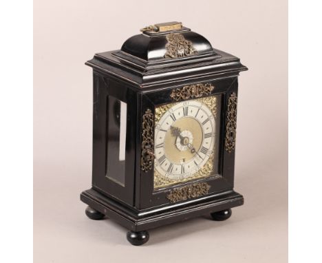 AN EARLY 18TH CENTURY EBONISED BRACKET CLOCK, the case applied with pierced mask and foliate scroll metal mounts, the 15cm sq