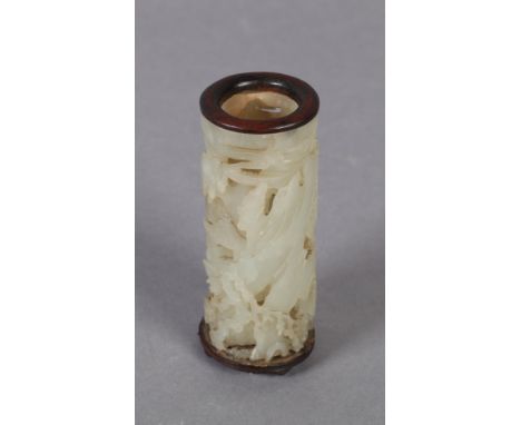 A CHINESE PIERCED AND CARVED JADE CYLINDRICAL POT decorated with mountainside, and relief carved with prunus and gingko trees
