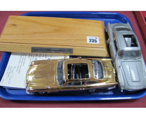 Two 1:24th Scale James Bond 007 Aston Martin DB5's, one gold, one silver, both with parts missing, damage with certificates.