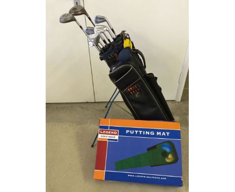 A set of gold clubs with standing caddy together with gold putting mat.