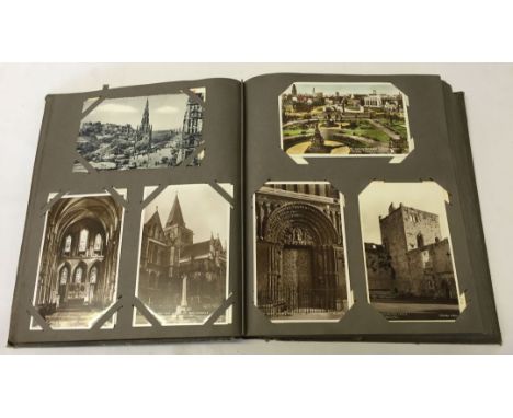 Approx 250 vintage photographic postcards in brown album with coloured tree panel to cover.