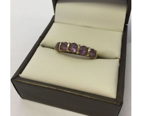 9ct gold dress ring set with five round amethysts. Size M.