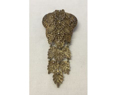 A vintage white metal filigree brooch, possibly continental silver. 8.5cm long.