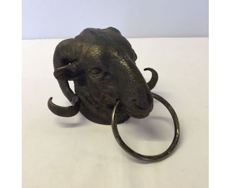 A reproduction cast iron rams head door knocker.