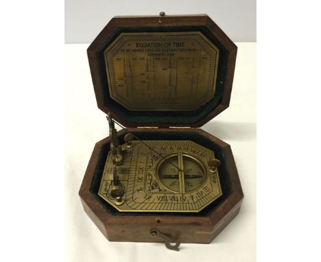 A reproduction boxed sundial compass.