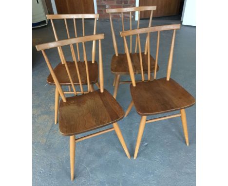 4 light wood Ercol style chairs.
