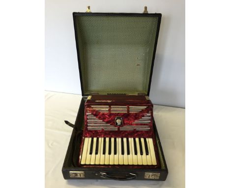 A cased Weltmeister Bandmaster Sonata accordian. One button missing.