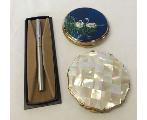 2 powder compacts - one decorated with swans on a lake, the other a Stratton compact with mother of pearl lid. Together with 