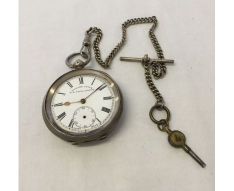 Silver cased pocket watch by H.E. Peck, London, with white metal watch chain and watch key. Glass and second hand missing. No