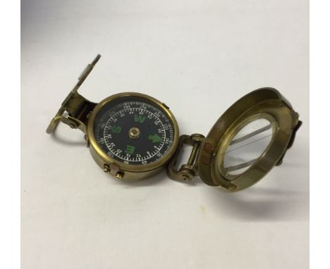 Brass hand held compass with glass lid.