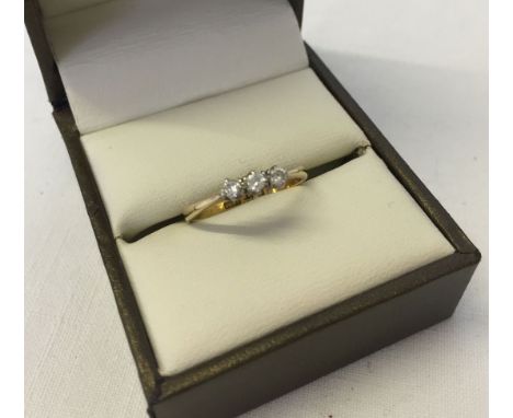 An 18ct gold diamond trilogy ring. Each stone approx 0.05 carat. Ring size M. Approx 1.8.