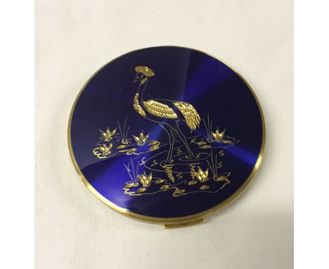 A Stratton ladies compact with East African Crowned Crane bird diamond cut decoration on blue enamel.