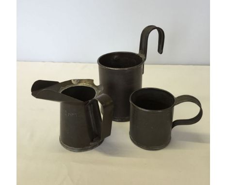 3 vintage tin measures: 1) a half pint oil jug. 2) a pint measure and 3) a half pint Victorian measure.