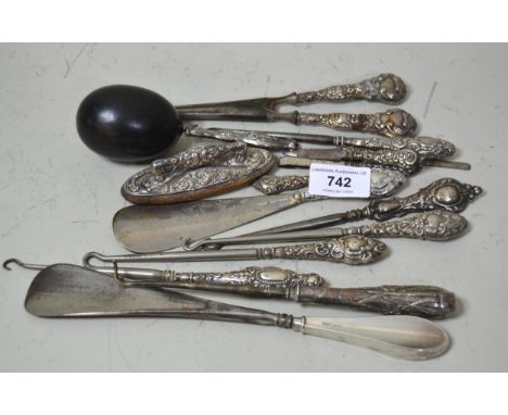 Bag containing a quantity of silver handled button hooks, manicure items, shoe horns etc.