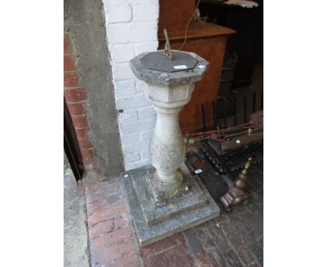 Weathered reconstituted stone garden sundial on a baluster column (at fault)