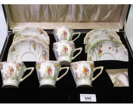 Cased floral enamel coffee set (lacking one cup) by Flosmaron
