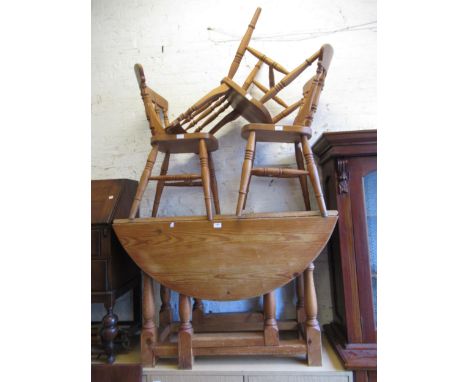 Oval pine drop-leaf dining table, three similar chairs, a bedroom chair, fire grate and a footstool