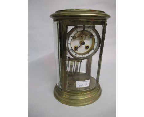 Late 19th / early 20th Century oval brass cased four glass library clock, the enamel dial with Roman numerals, the two train 