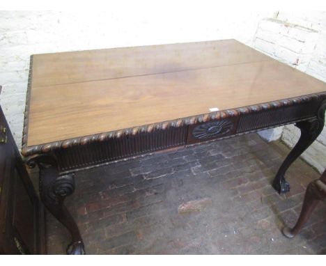Late 19th / early 20th Century mahogany writing table in Irish Chippendale style, the gadroon moulded top above a carved frie