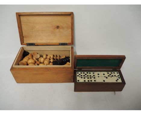 Ebony and boxwood chess set in a pine box, together with a mahogany cased set of bone and ebony dominoes