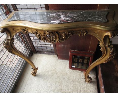Early 20th Century carved and gilded console table, the shaped marble inset top above a pierced frieze and cabriole supports,