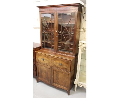 George IV mahogany and inlaid secretaire bookcase, the moulded cornice above two astragal glazed doors, the base with a fitte