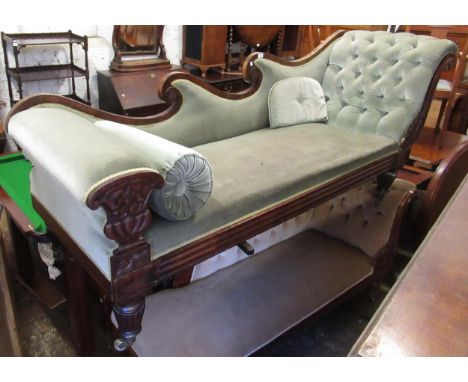 William IV mahogany and button upholstered chaise longue, the shaped scroll back above a carved and reeded frieze, on turned 